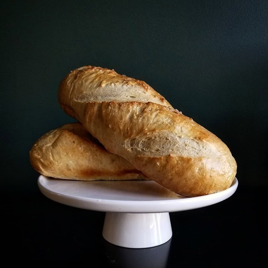 Two baguettes on a cake stand